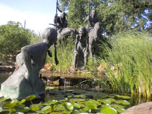 These beautiful sculptures are at a park in Wichita Falls. The landscaping superbly showcases the scene.