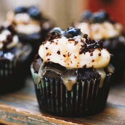 Chocolate cupcake with caramel filling topped with cream cheese frosting.