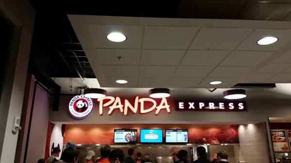 It is inside a big building that is half panda and half canes chicken