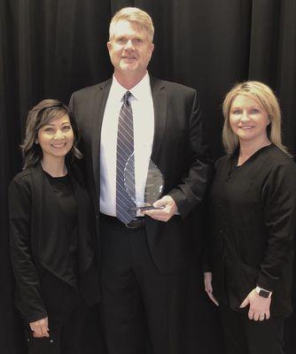 Dr Holifield and wife Thy along with Tanya Taylor accepting the Emerging Business of the Year Award