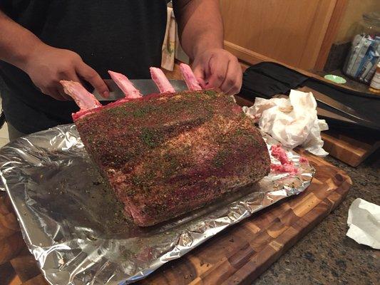 Cleaning, trimming and seasoning a prime rib for a Christmas dinner party. Only quality meats and in-house freshly ground herbs are used.