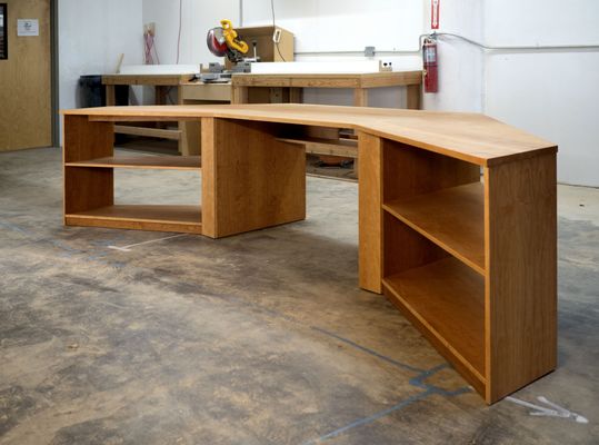 Custom wood desk for a music studio in solid cherry. Custom shape desk built in to an alcove