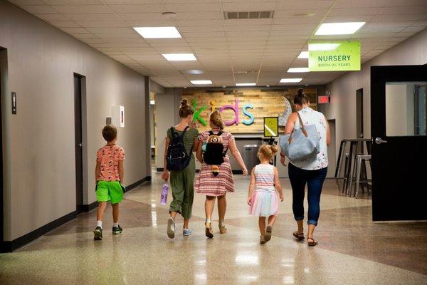 Family heading downstairs to Kids Ministry