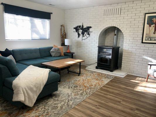 A renovated living room with new luxury vinyl floors and paint