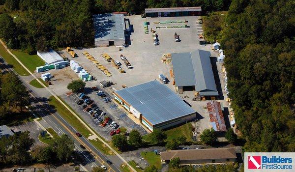 Building materials supplier Builders FirstSource's forklift is moving wood roof trusses.