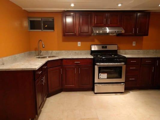 Mahogany Kitchen with Corner Sink and Brushed Nickel Faucet