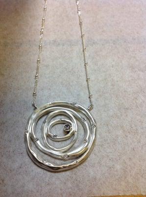 sterling silver nesting circle pendant set with customers diamonds.