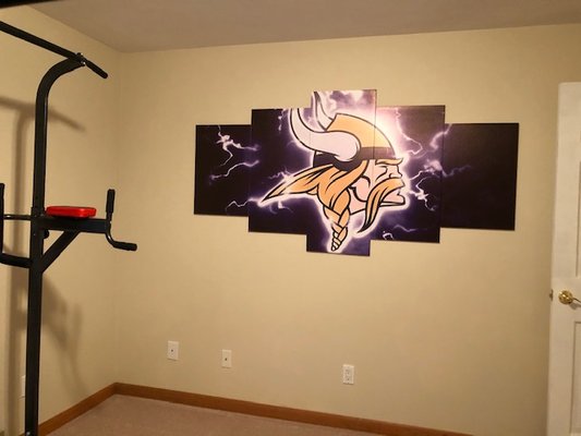 Canvas hung Vikings Logo for our in-home gym room.