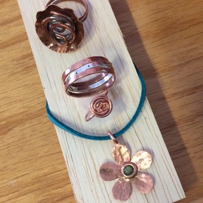 Hammered Sterling Silver and Copper rings/copper flower on suede cord.