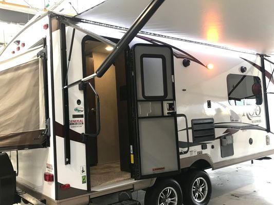 This is our 21' Rockwood Roo . It has a slide out and front and back pop out beds so it sleeps 6 .