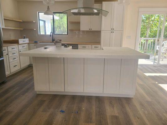 Kitchen remodel with cabinets, butcher block countertops, concrete countertop, floating shelves, range hood installation, the full job.