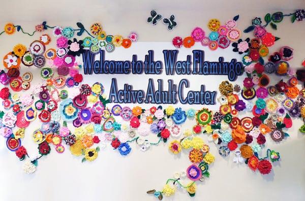 A mural of flowers greet visitors, all made here at the center from donated yarn.