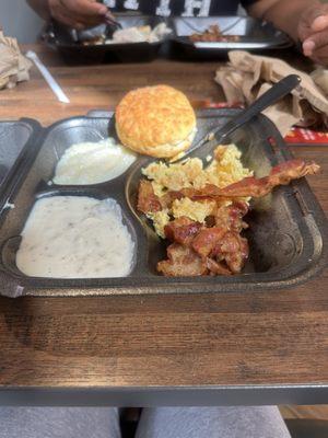 Hard, Dry biscuit, bacon pieces and cold grits.