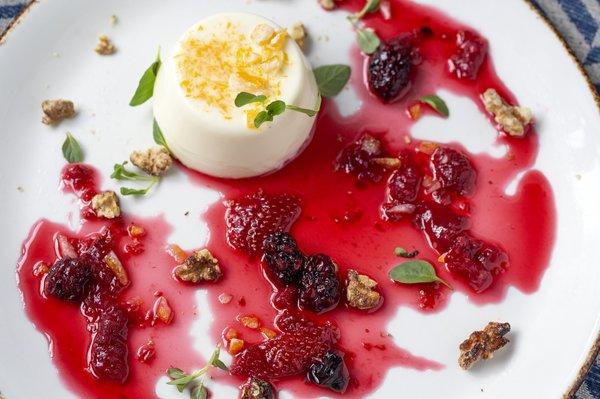 PANNA COTTA ALL'ARANCIO with fresh orange panna cotta, house made berry jam, mint, candied orange zest & candied walnut