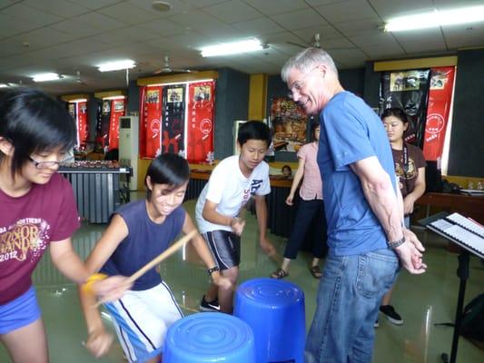 Rehearsing the garbage can piece during the 2012 tour in China.