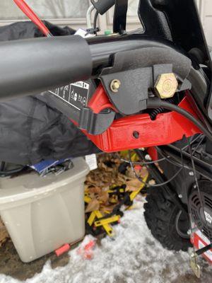 Red handle broken. This help the snowblower turn right and left.