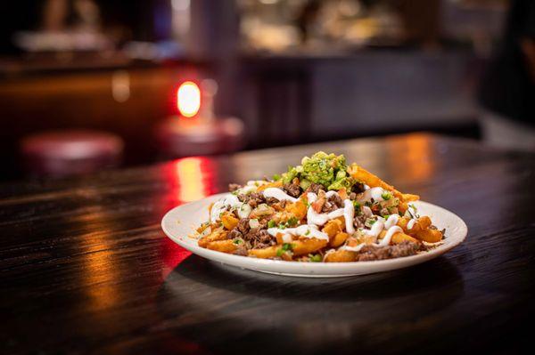 Carne Asada Fries with Nacho Cheese, Pico De Gallo, Guacamole, Sour Cream, Jalapeños