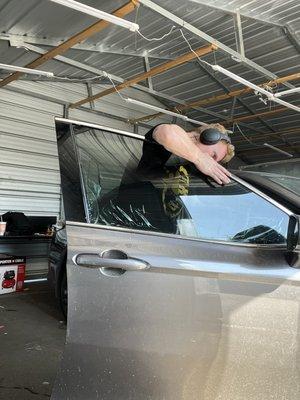 Window tint being fit onto window for installation