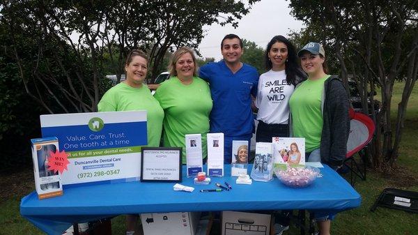 Team duncanville dental care at a community event.