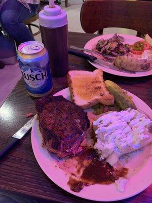 Large ribeye with baked potato, jalapeños, tomatoes, pickle, Texas toast