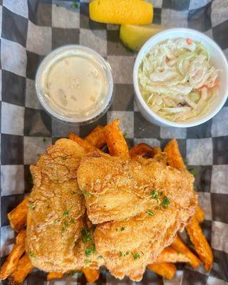 Fish and chips over top of sweet potato fries (one dollar extra) with coleslaw and tartar sauce.