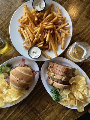 Basket of crispy French fries with seasoned sour cream, thick cut bacon cheeseburger and Sweet onion patty melt.