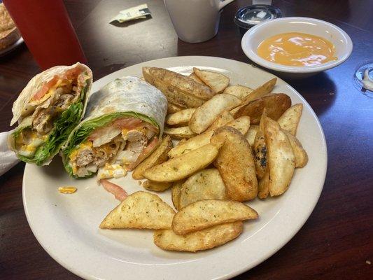 Chicken ranch wrap, no spinach, add raw onion, potato wedges and cheese sauce on the side! Coffee is great too!