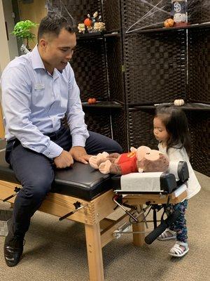 Explaining to this kiddo what to expect on her adjustment.  This little girl had constipation issues and was helped with chiropractic