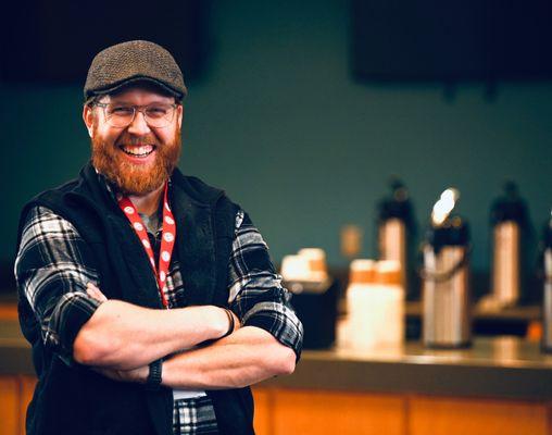 Guest Services team member smiling to welcome friends before church service in Joplin.