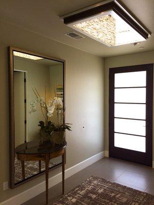 An amazing detail for an entryway in a client's residence with a custom ceiling fixture.