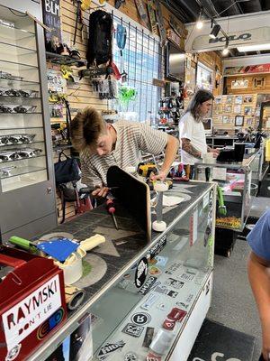 Putting on new wheels and trucks on the skateboard we bought in Scotland.