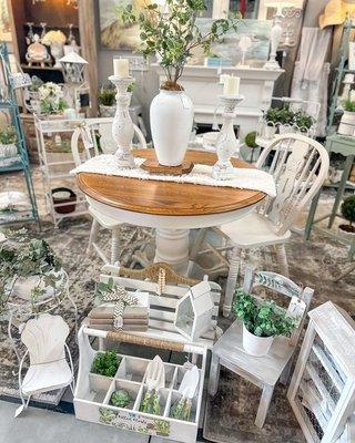 Cozy offers beautifully upcycled furniture & decor. Their whites, earthy tones, and natural wood are accented with greenery. Cozy