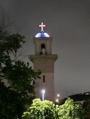 The cross looks lovely, lit up at night