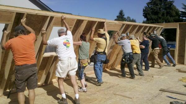 Volunteers build homes for families