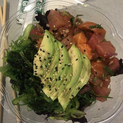 Salmon and yellowtail poke bowl over mixed greens