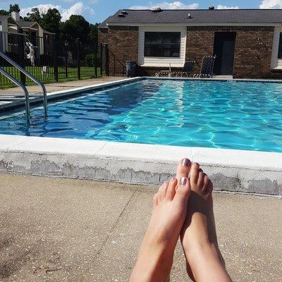 One of TWO pools available at the apartments along with the laundry facility and fitness area in the building behind.