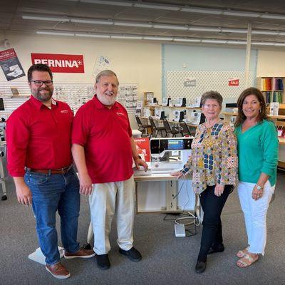 AllBrands.com purchases Fabric Boutique from owner Shirley Warren. Pictured from left to right are John Douthat Jr, John Douthat Sr, Shirley