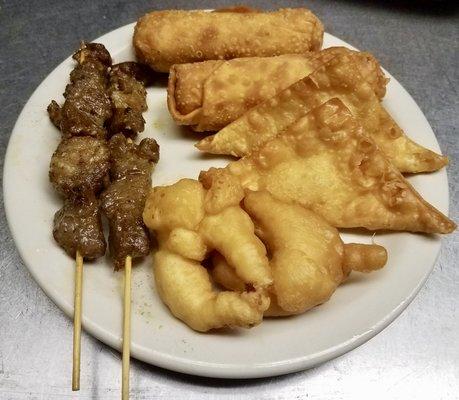 Our 'Combo Platter' featuring an assortment of tasty appetizers: 2 Teriyaki Beef Stick, 2 Egg Roll, 2 Crab Rangoon, and 2 Fried Shrimp