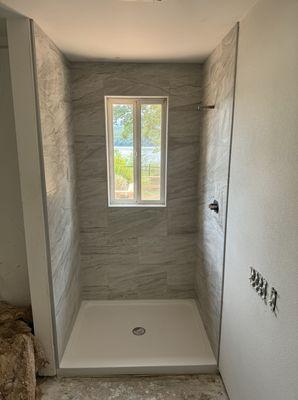 Tile shower walls on shower pan insert.