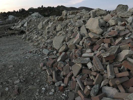 Regulators observed roofing material, and pool demolition debris.