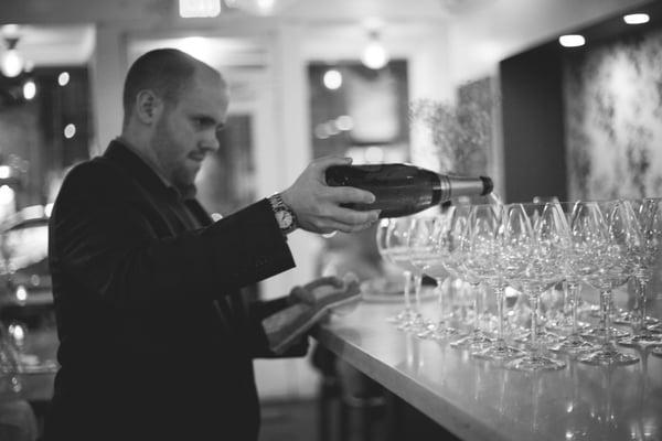 Nick Davis of Medium Plus pouring glasses of champagne