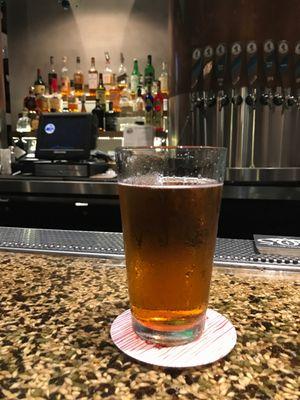 A Sunny Jim's IPA. Note the "bar-ley": grains and hop pellets embedded in the bar top.