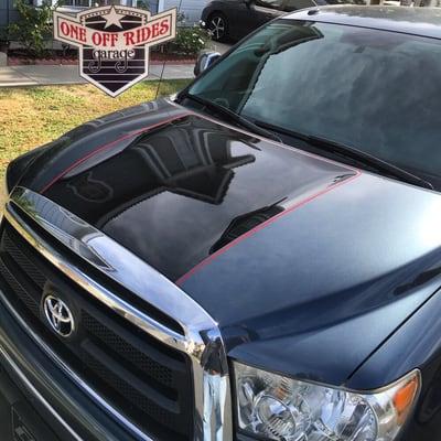 Black Stripe and red pinstripe painted on this Tundras hood.