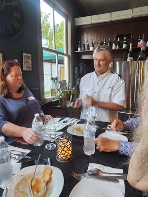 Another picture of the owners, displaying the wine