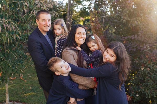 A mother and father with their 4 kids at a family photo session