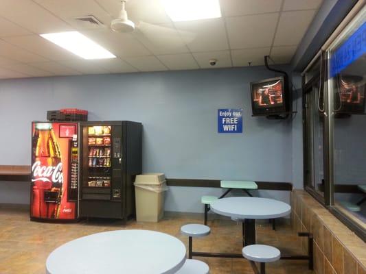 Vending machines and TV in sitting area.