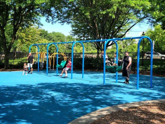 View of the new (installed Fall 2019) playground, including swings where both child and adult can swing together.