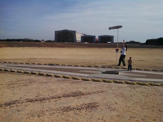 Ground Zero.  This marker was placed 50 years post crash at the spot where the Hindenburg landed   The background is Hangar 1.