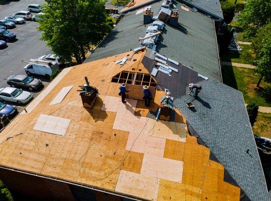 Aerial drone of apartment shingle re-roof.