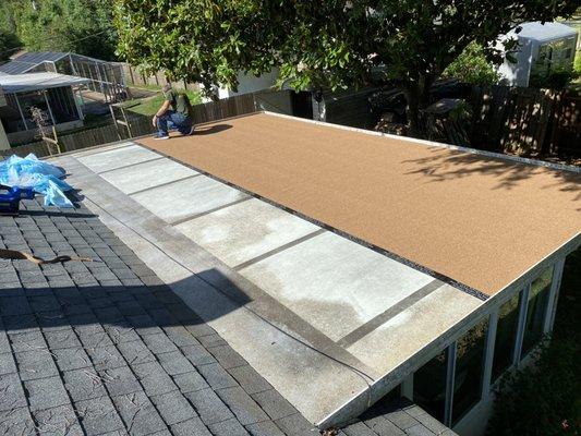 Insulated metal roof recovery with granulated modified roofing